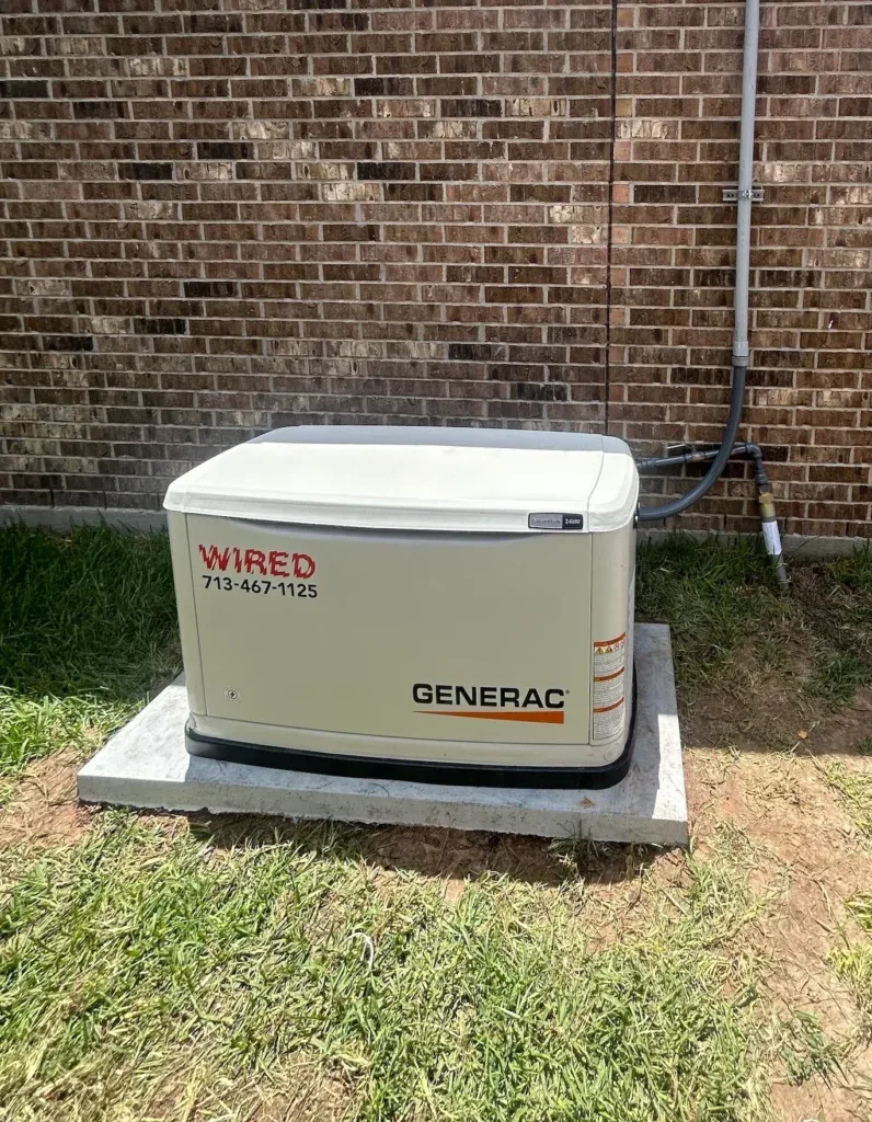 Wired-installed Generac against a brick wall, service lines in conduit