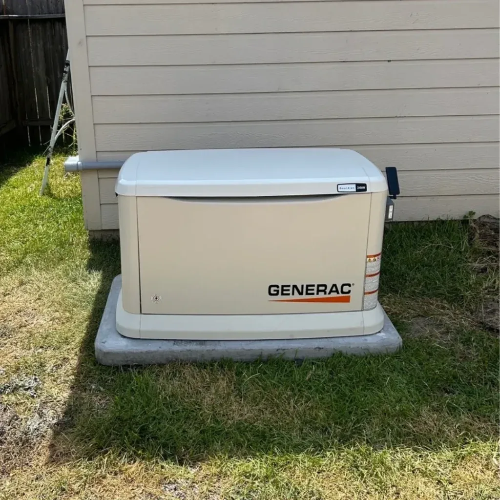 A Guardian standby unit set on a level pad next to the home