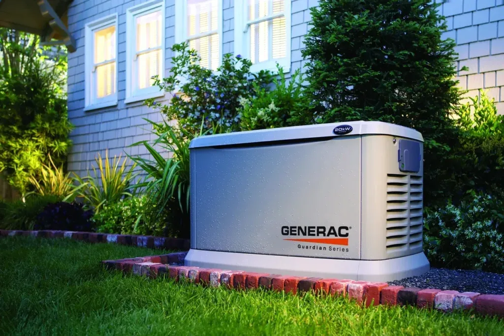 Generac Guardian on its pad beside the house, gas and electrical lines run and finished