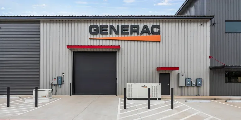 Generac-branded warehouse entrance with generators out front