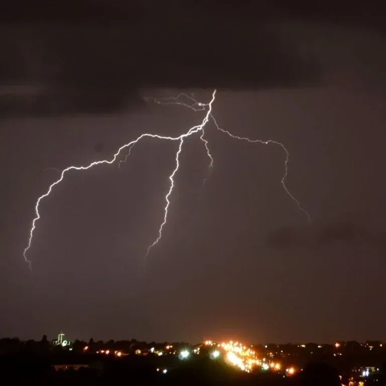 Lightning bolt over a city skyline at night